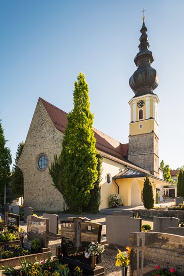 Expansion at the west side of the church, conglomerate-stone wall, southern entrance with porch roof